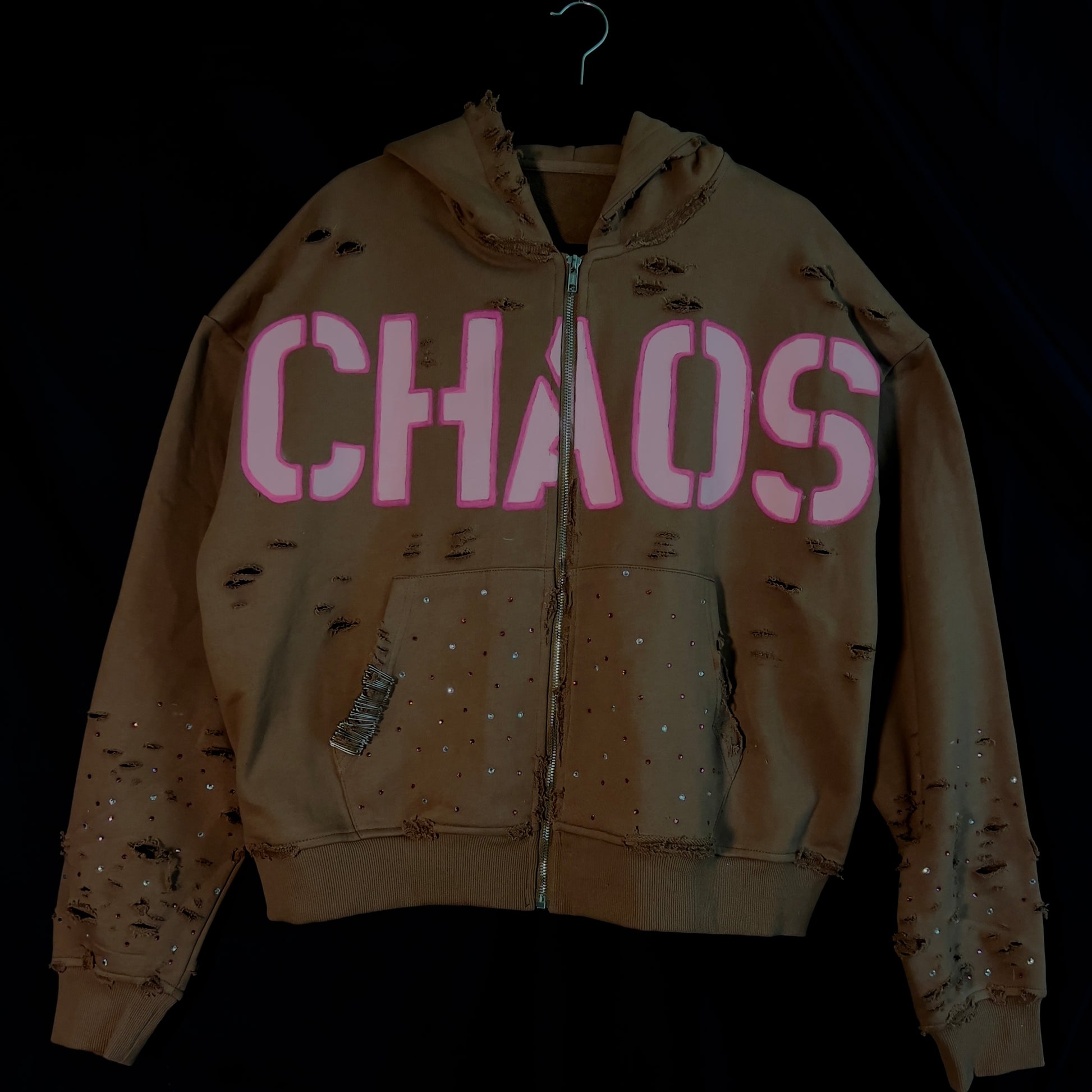 Heavy-distressed brown hoodie with pink hand-painted text, rhinestone embellishments from Prescelti Studios’ ‘A Beautiful Chaos’ collection.”